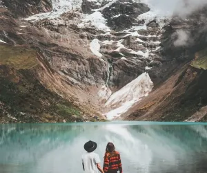 Couple enjoying the alpine lake | Peruvian Trek Expeditions Couple enjoying the alpine lake | Peruvian Trek Expeditions